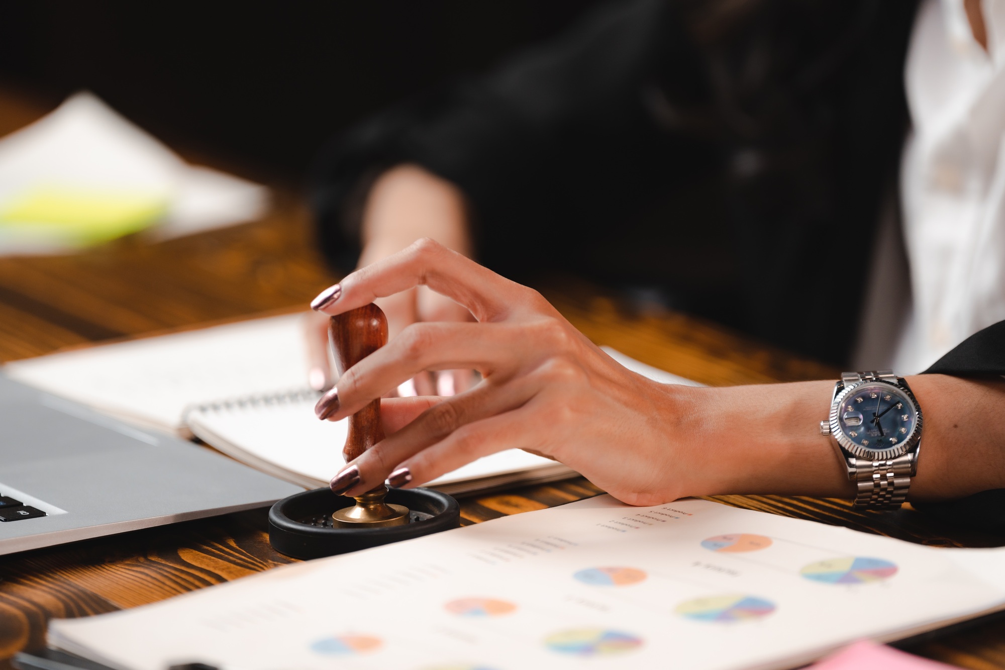 Stamping with approved stamp on certificate document public paper agreements at desk of notary